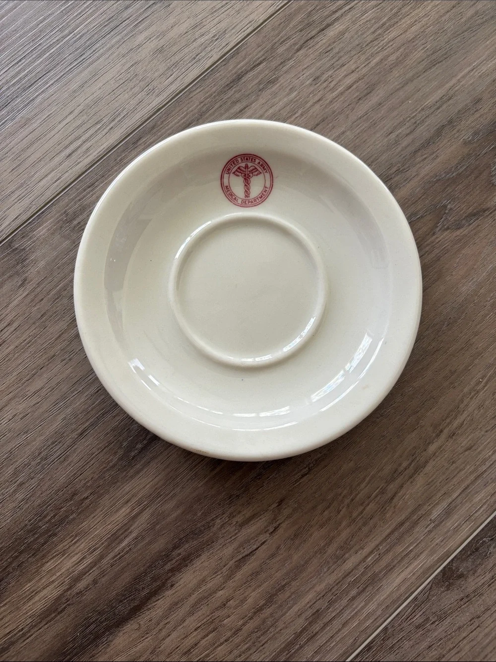 Cream Ceramic Saucer with Red Accent Logo